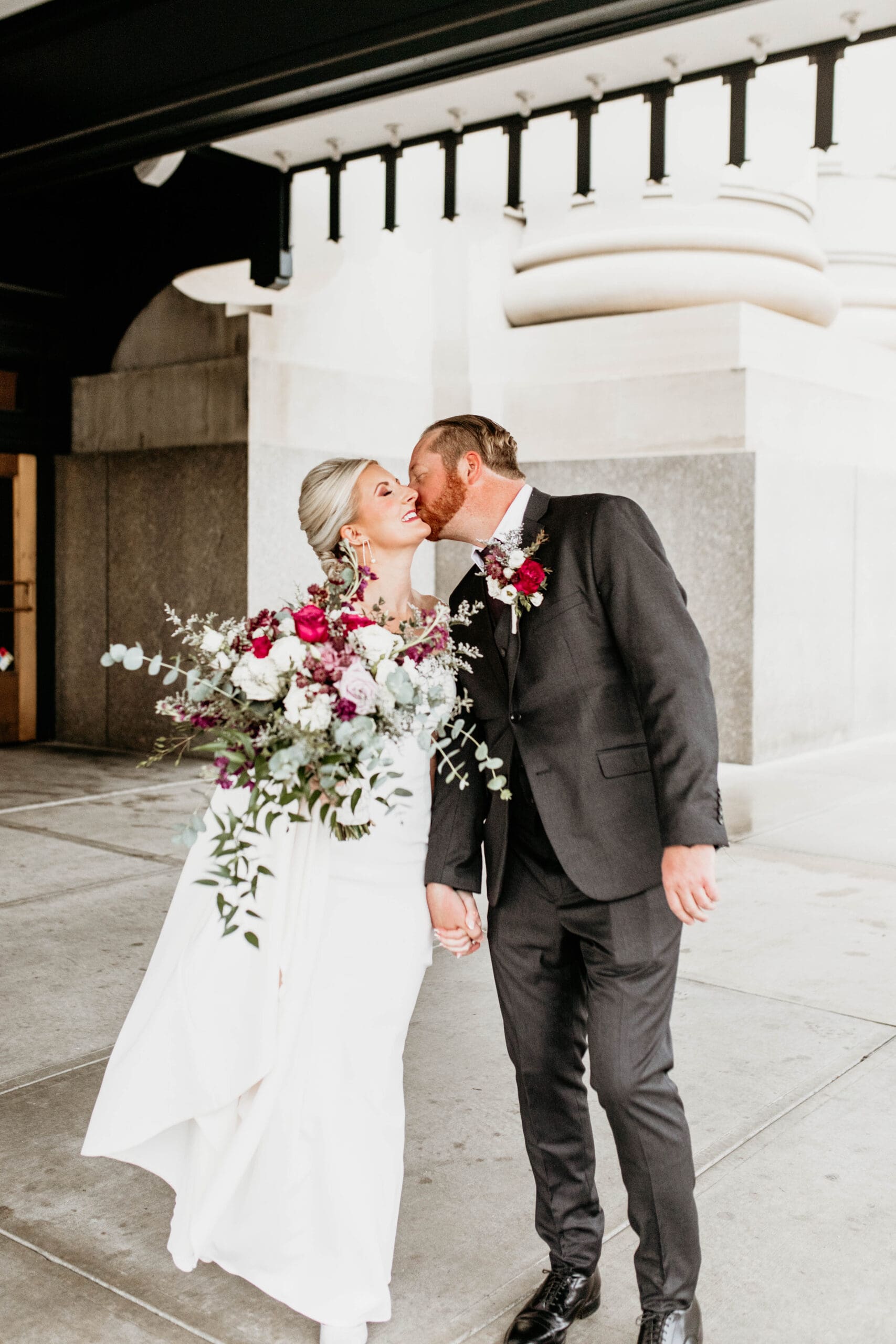 Couple kissing outside Union Station.