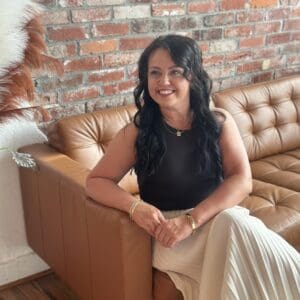 Lady sitting on couch.