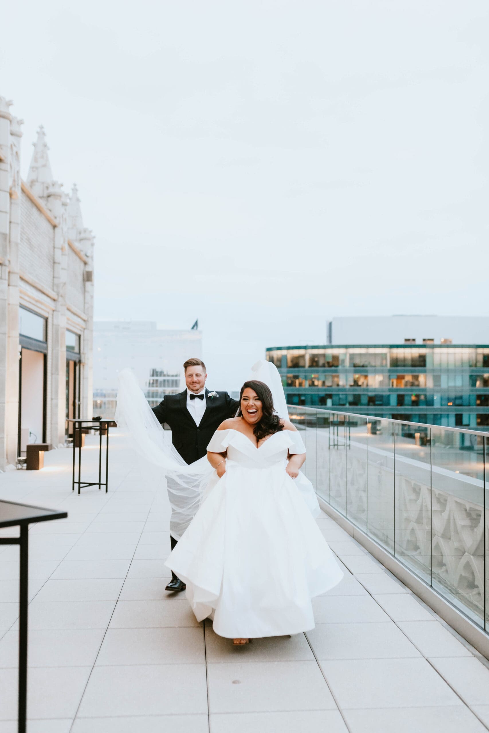 groom holding brides veil