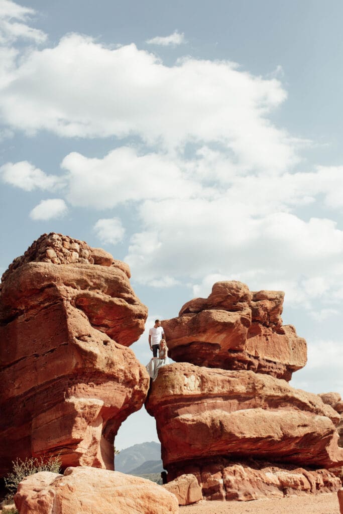 Bride and groom posing on colorado springs rocks 