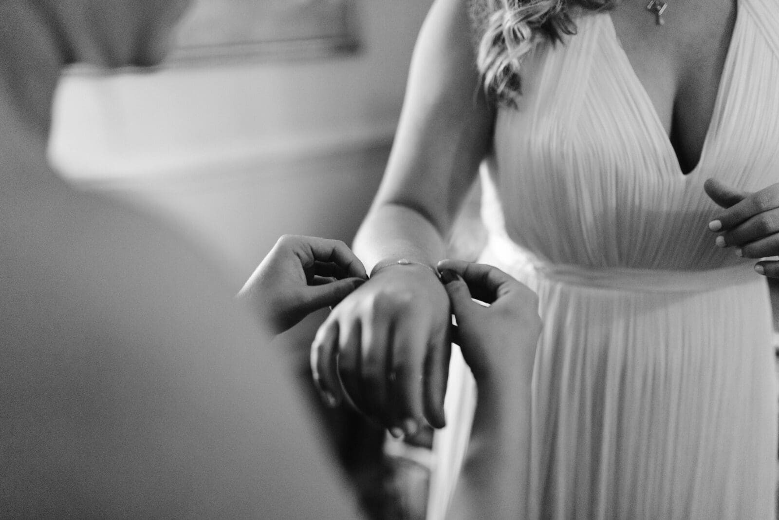 Wedding dress hanging from a porch with trees in the background.