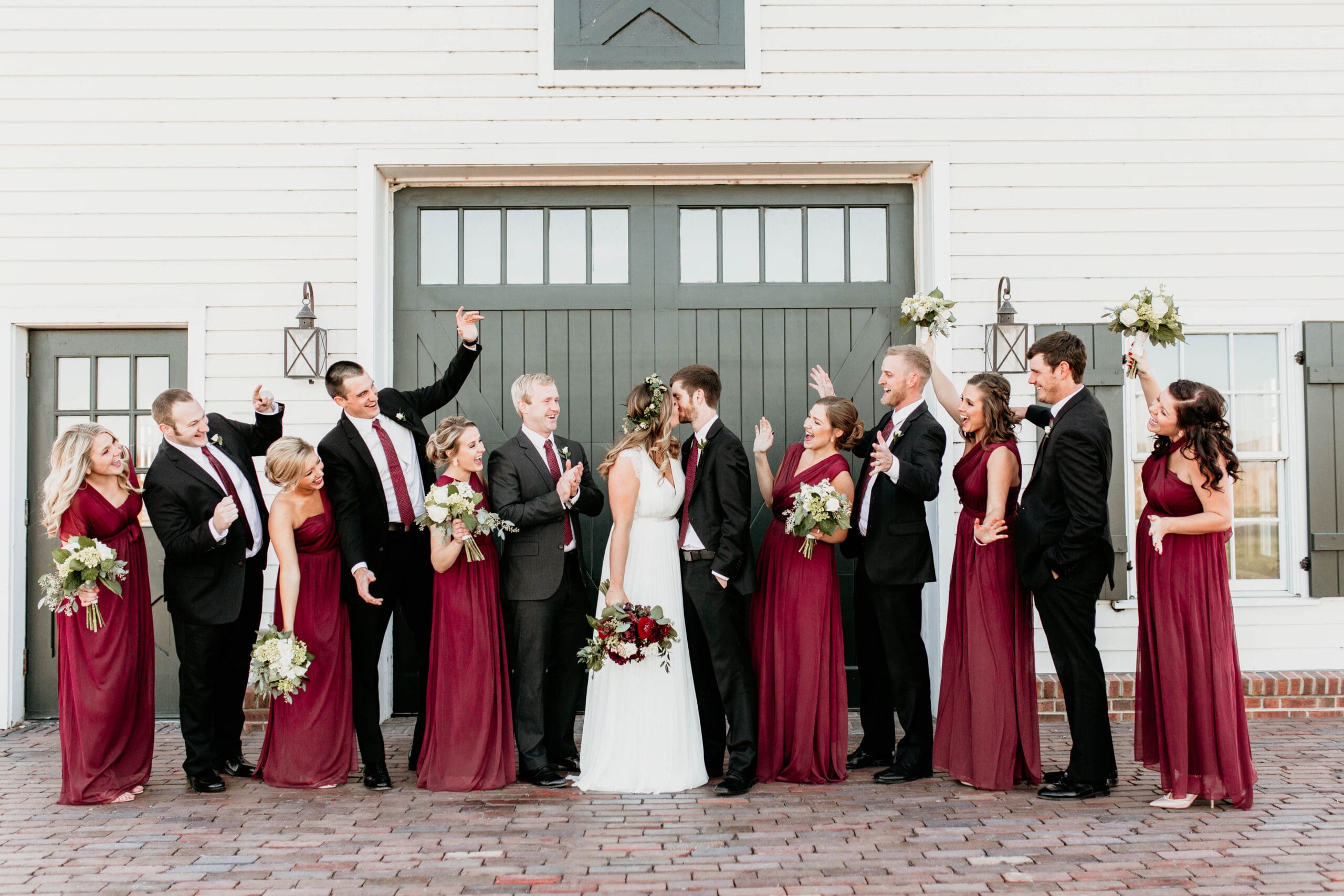 Bridal party cheering on bride and groom
