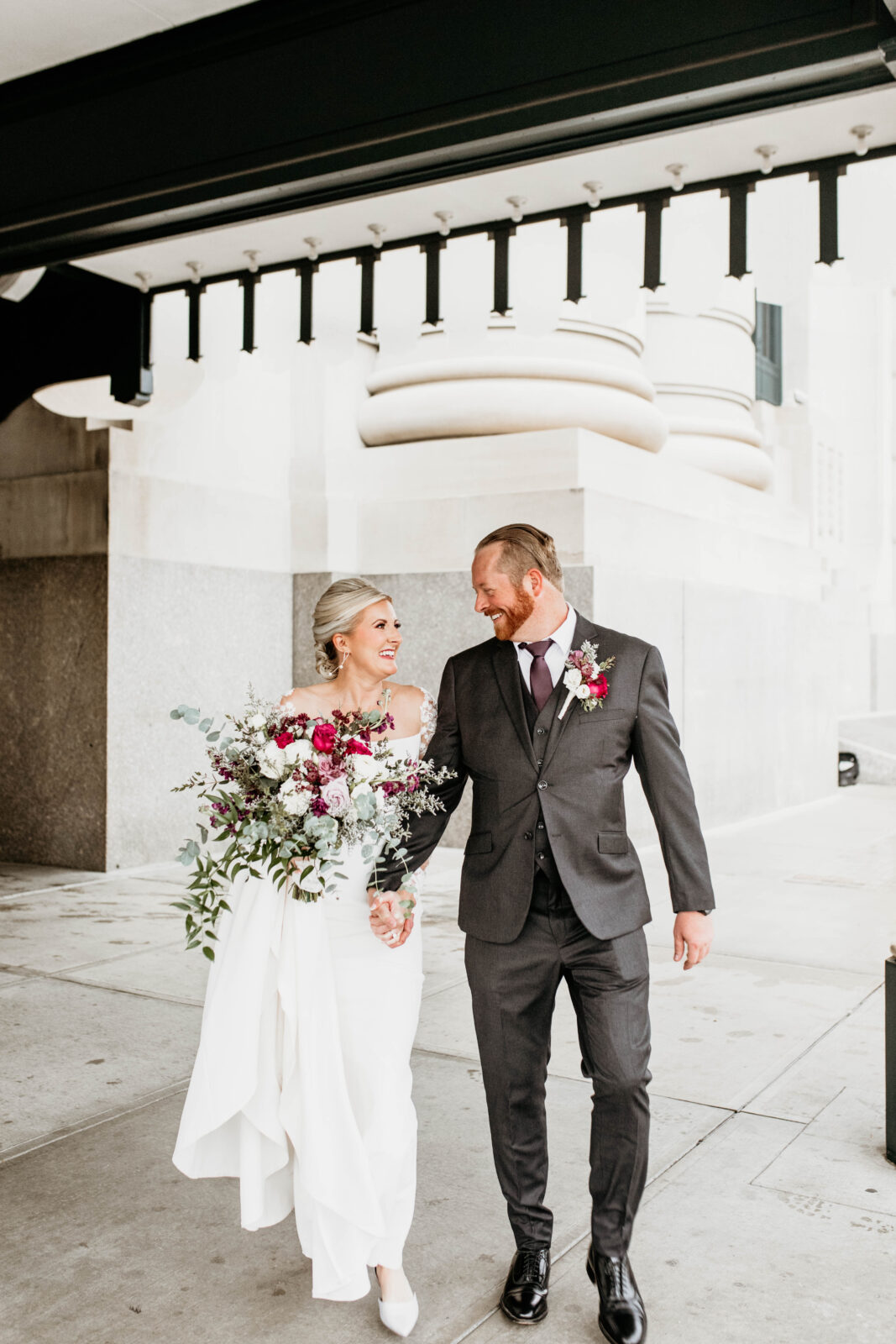 Couple walking hand in hand after their wedding. 