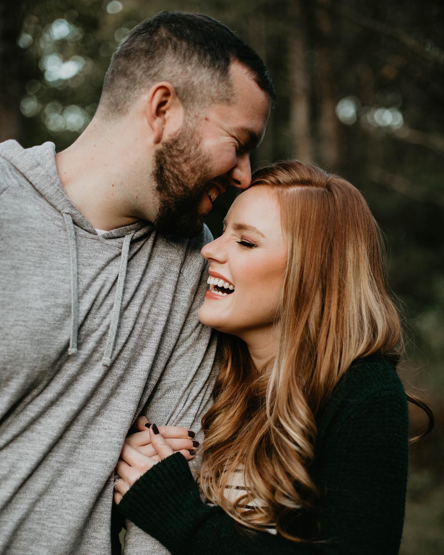 Couple coming in close for a kiss during their engagement photos.