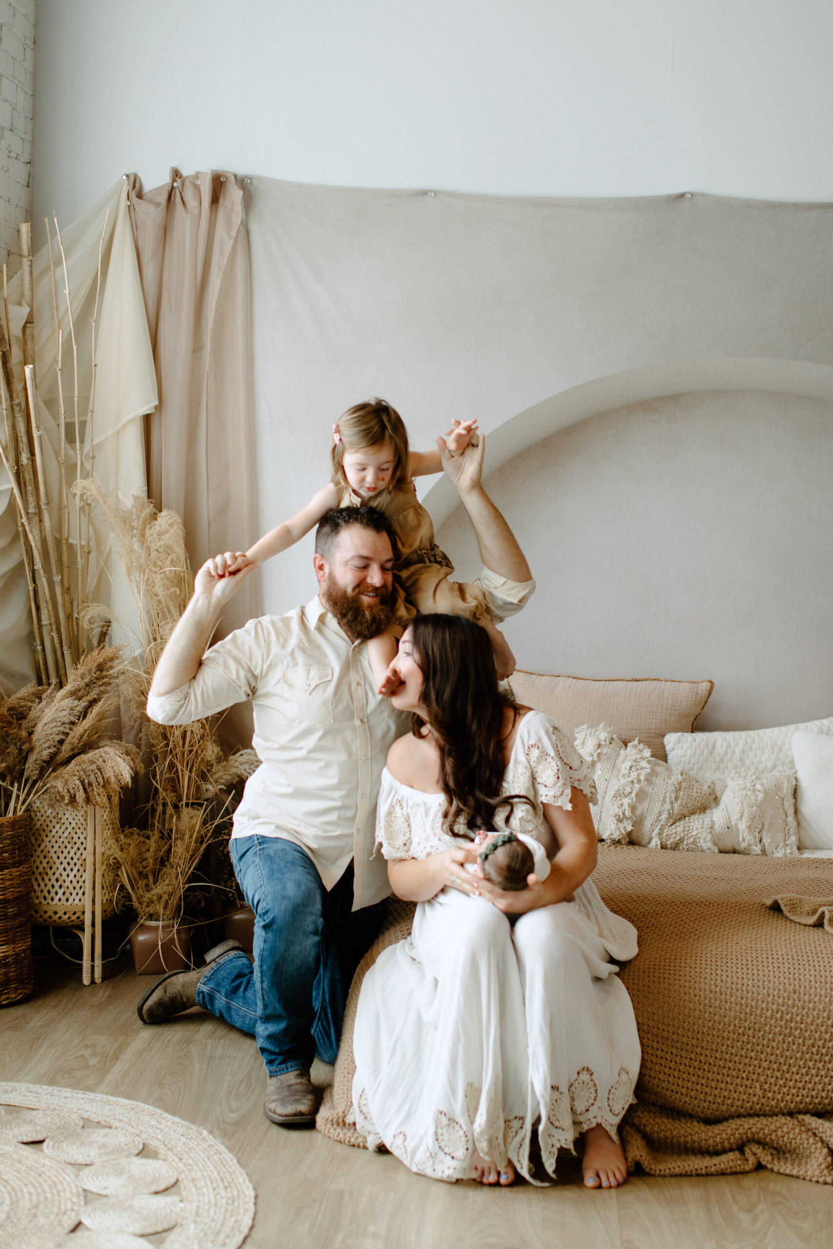 Family Posing on bed with newborn