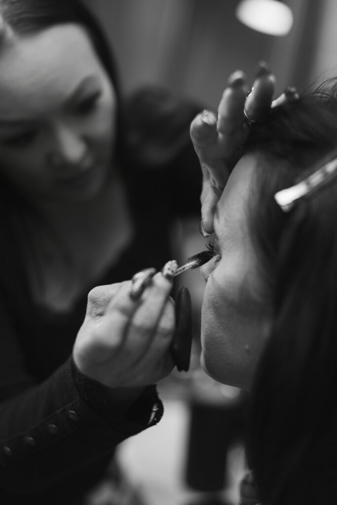 Bride getting hair and makeup done before wedding.