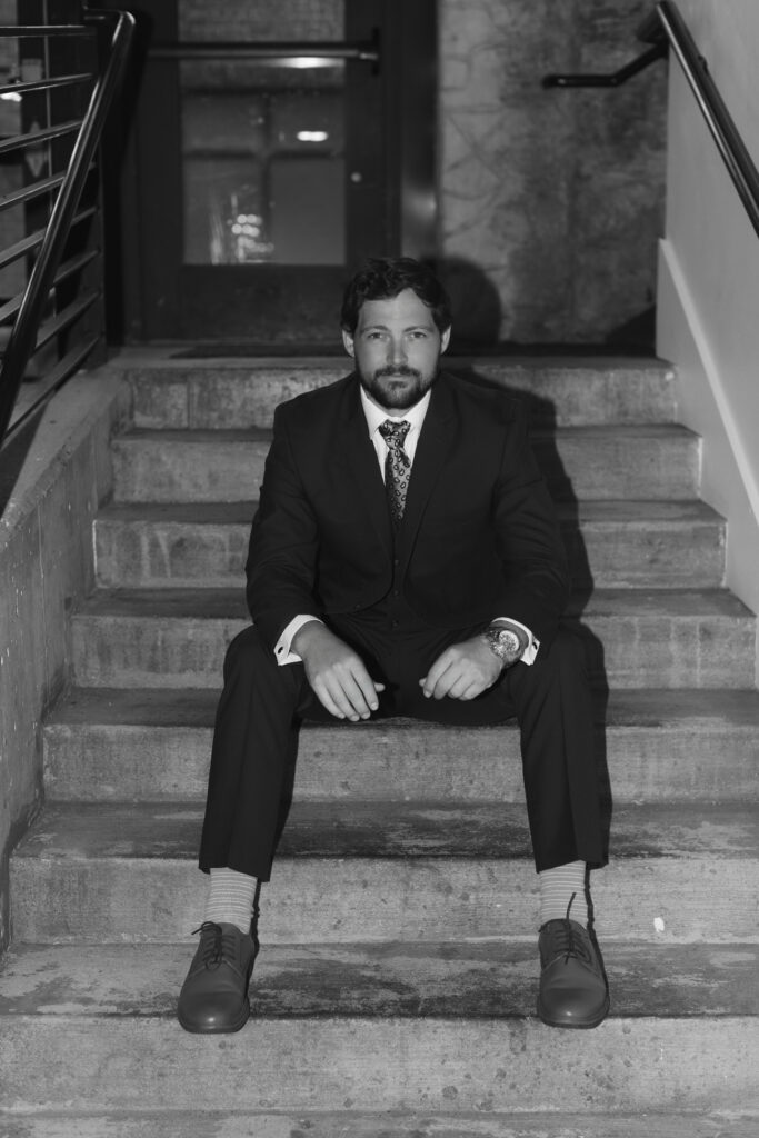 Groom sitting on stairs