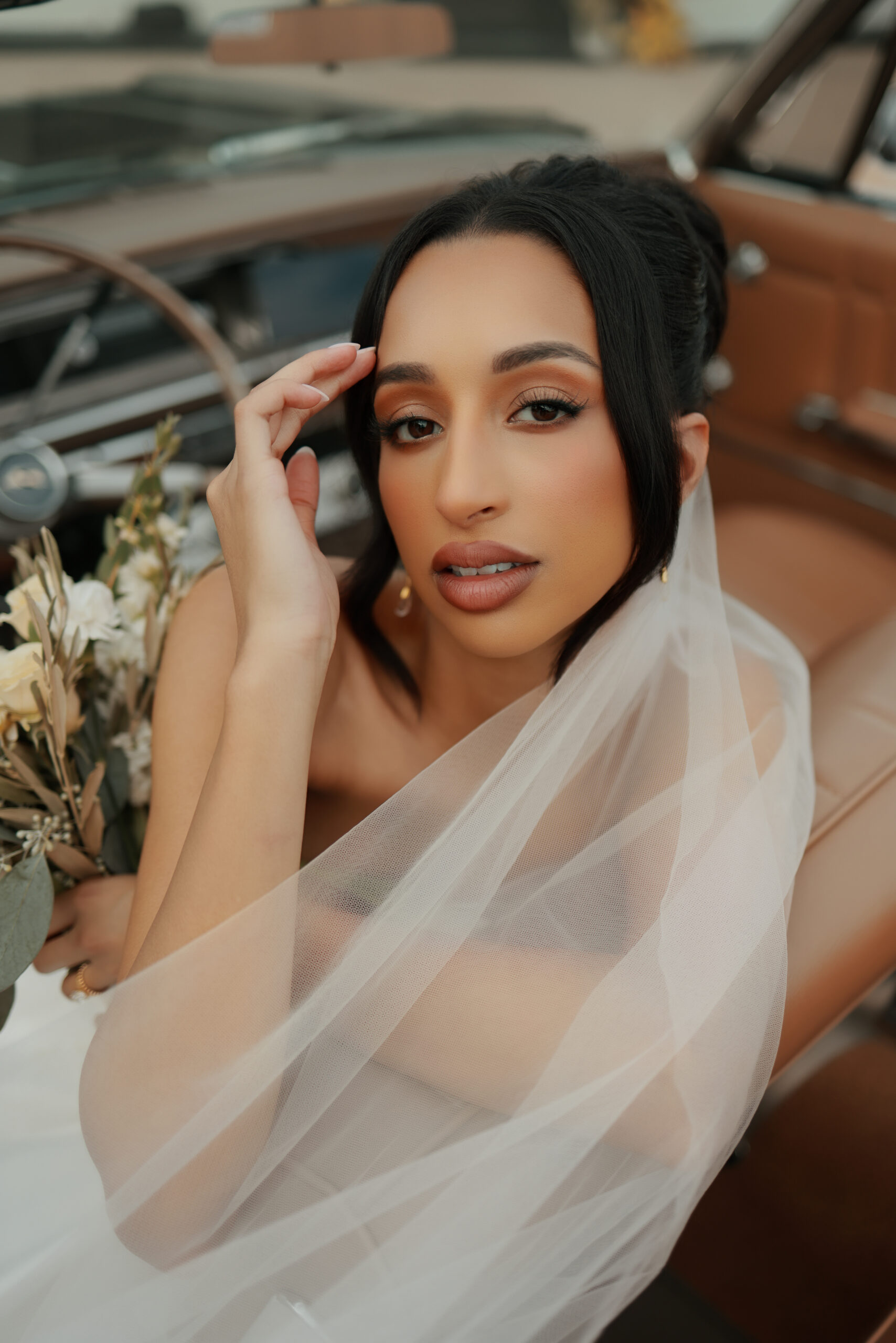 • Bride adjusting veil before luxury Atlanta wedding