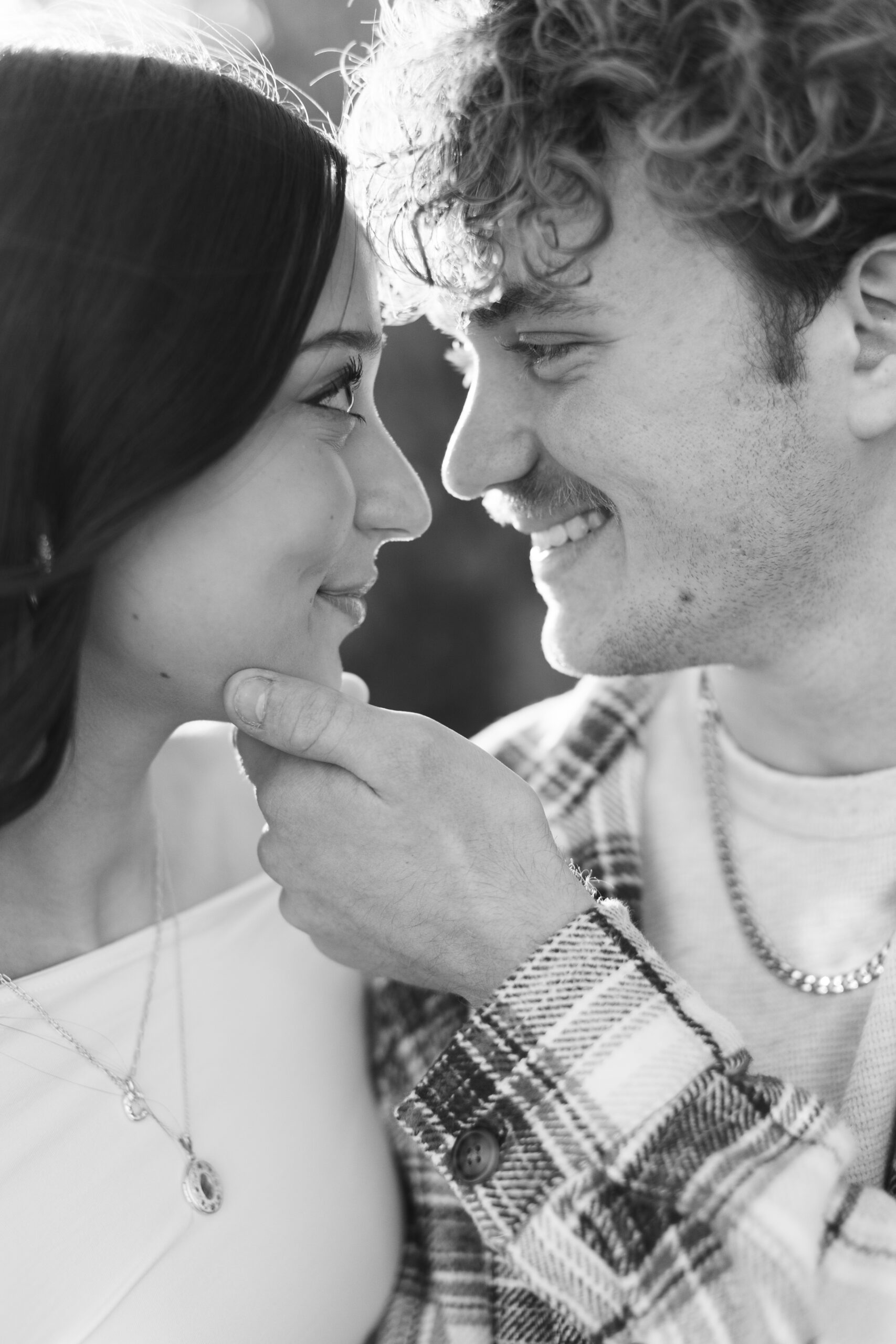 Kansas City newborn photography parents sharing an intimate, close-up moment, highlighting connection, emotion, and timeless documentary-style family storytelling.