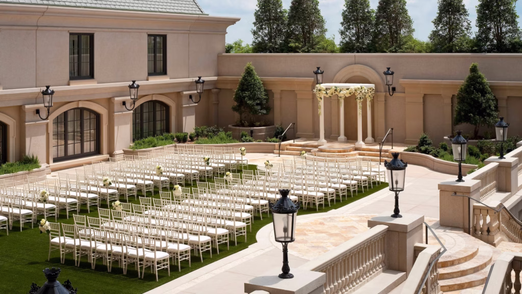 Luxury outdoor ceremony space at The St. Regis Atlanta with floral arch and elegant seating