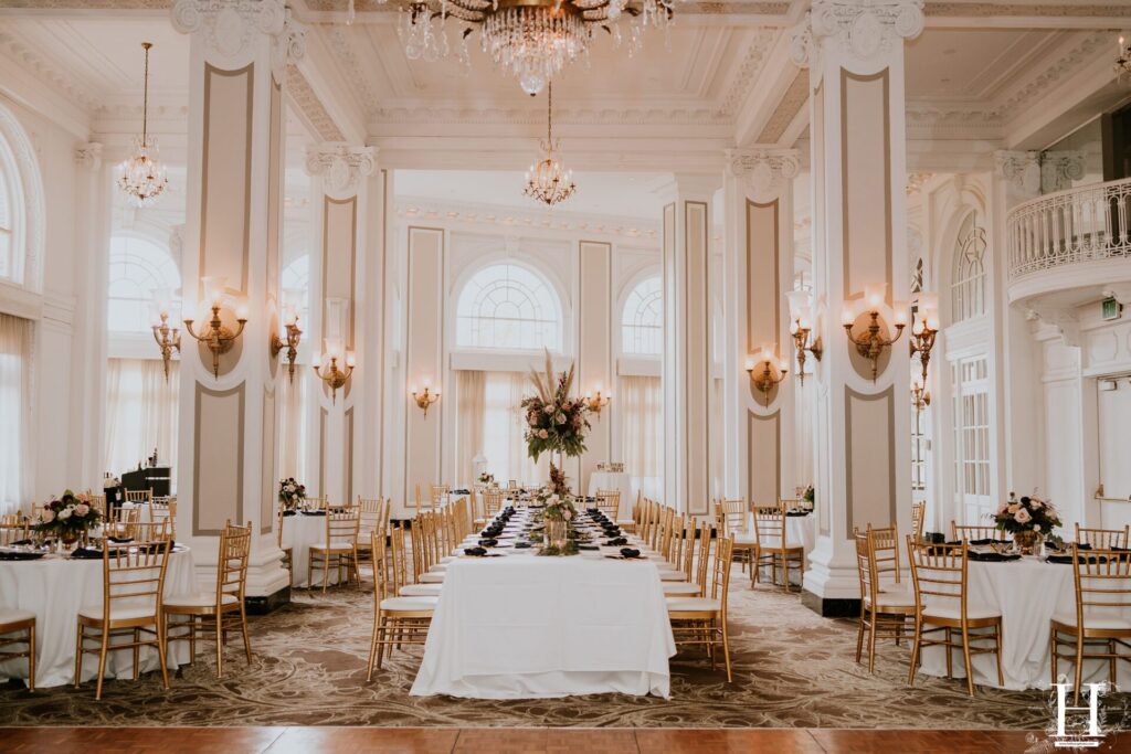 Reception setup inside The Georgian Terrace Atlanta wedding venue featuring grand ballroom, tall columns, chandeliers, and elegant historic architecture in Midtown Atlanta Georgia
