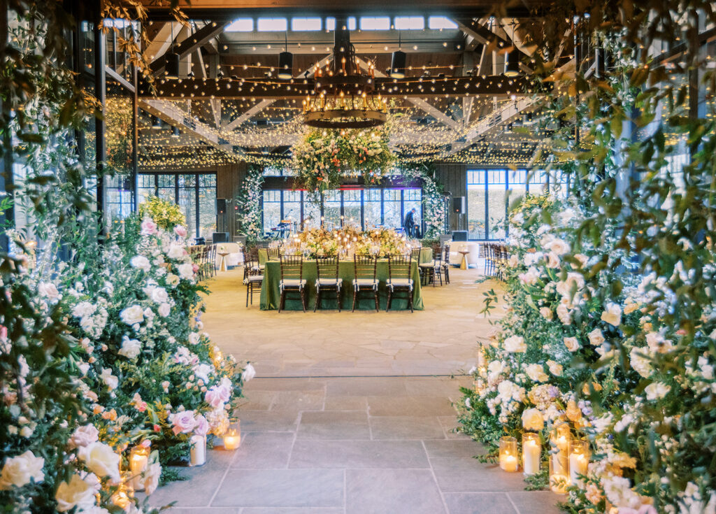 Luxury reception setup at The Farm at Old Edwards wedding venue featuring floral installations, candlelight, and elegant mountain estate reception space